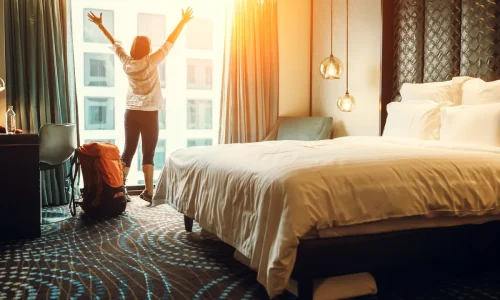 Woman-throwing-open-hotel-curtains